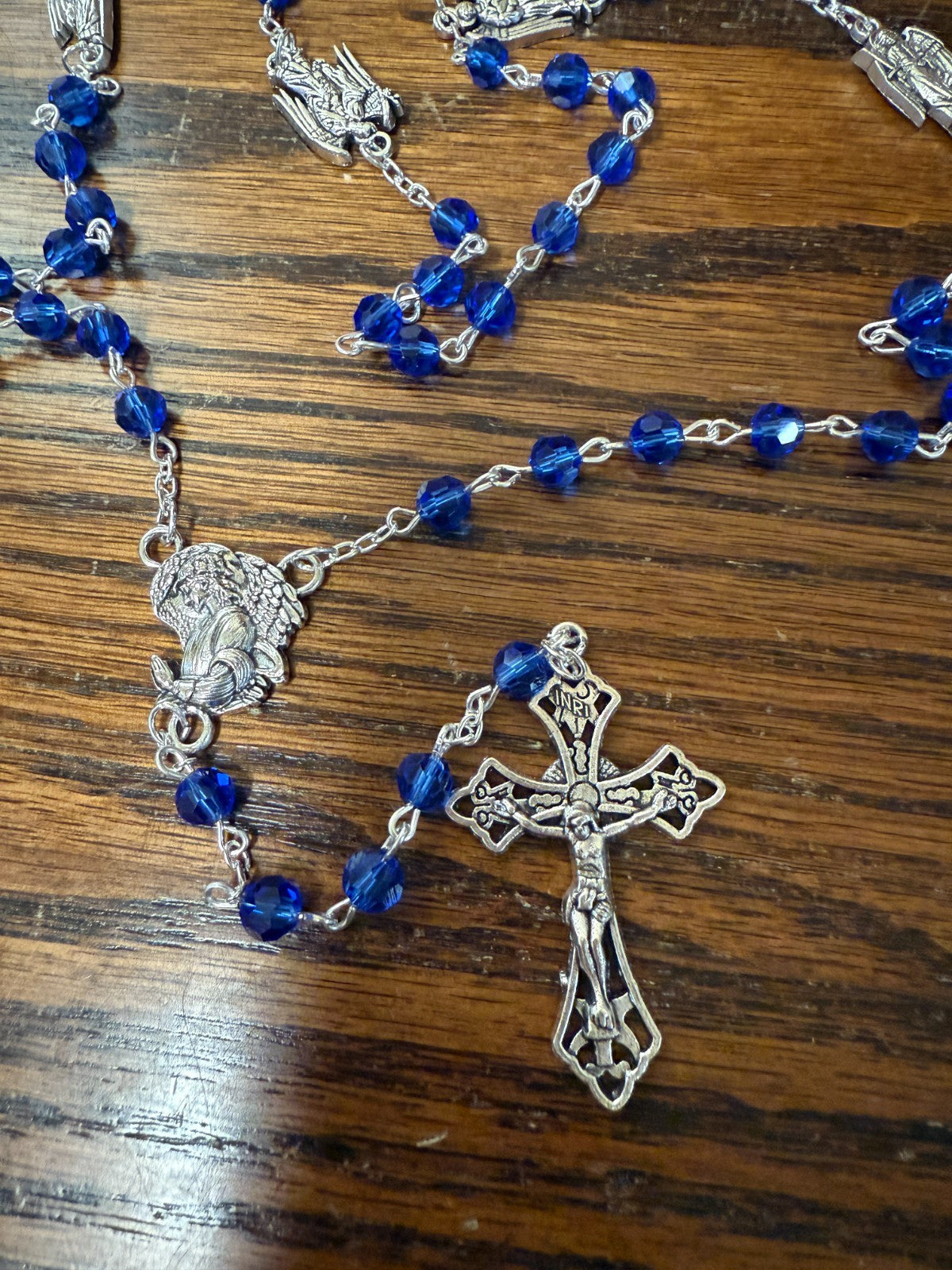 Blue glass beads rosary featuring Saint Michael and archangels, with Christian medals, by Bob and Penny Lord.