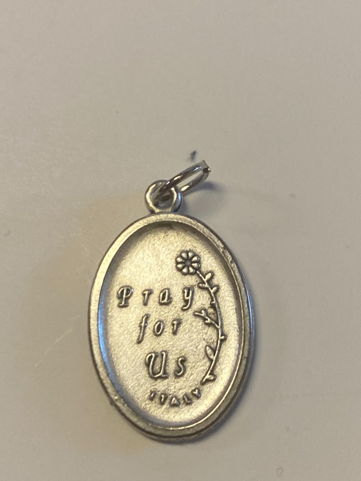 Saint Philomena silvertone medal from Bob and Penny Lord, featuring religious symbolism and intricate design.