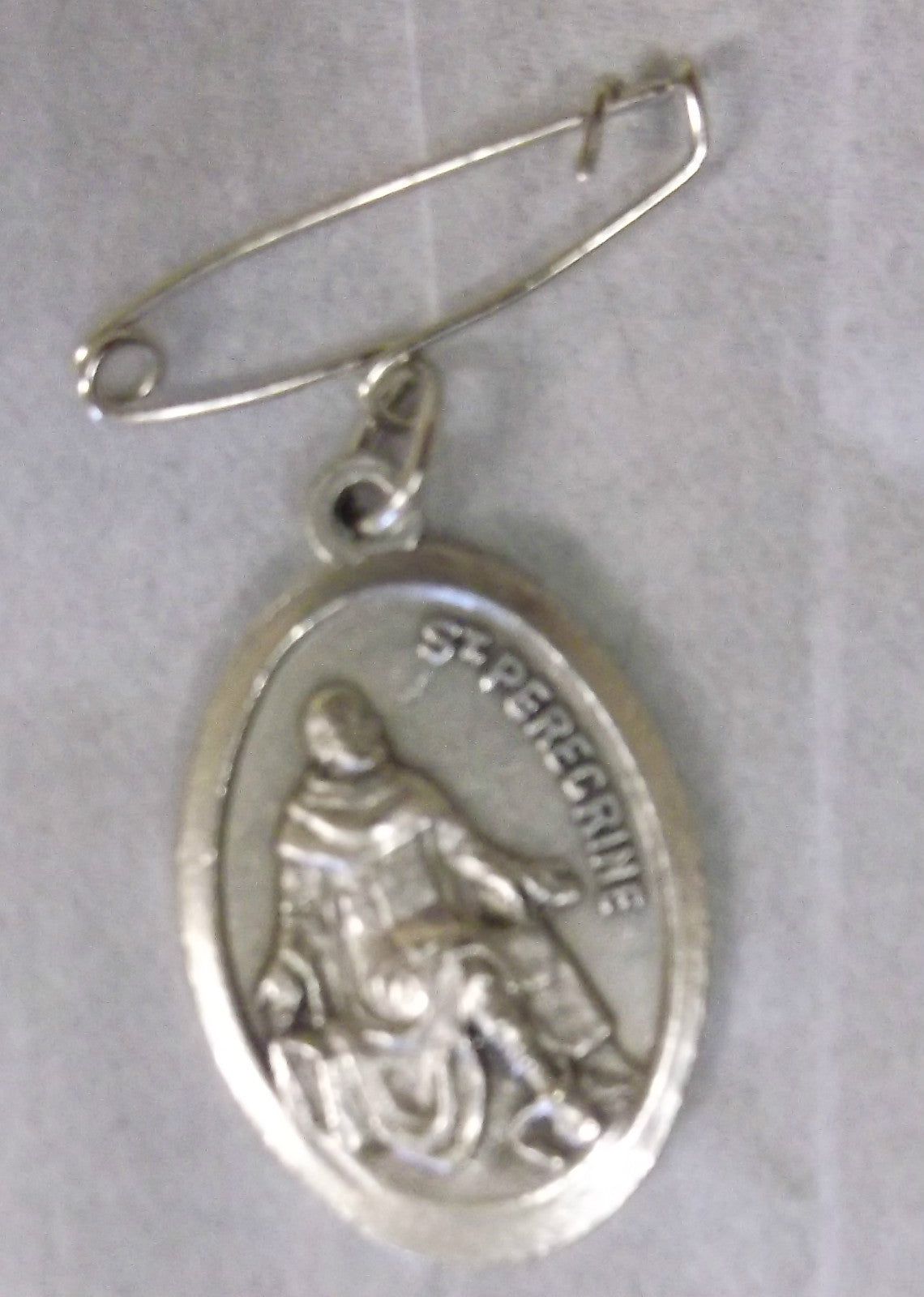Saint Peregrine Cancer Saint medal relic with detailed religious design, collectible Christian relic from Bob and Penny Lord.