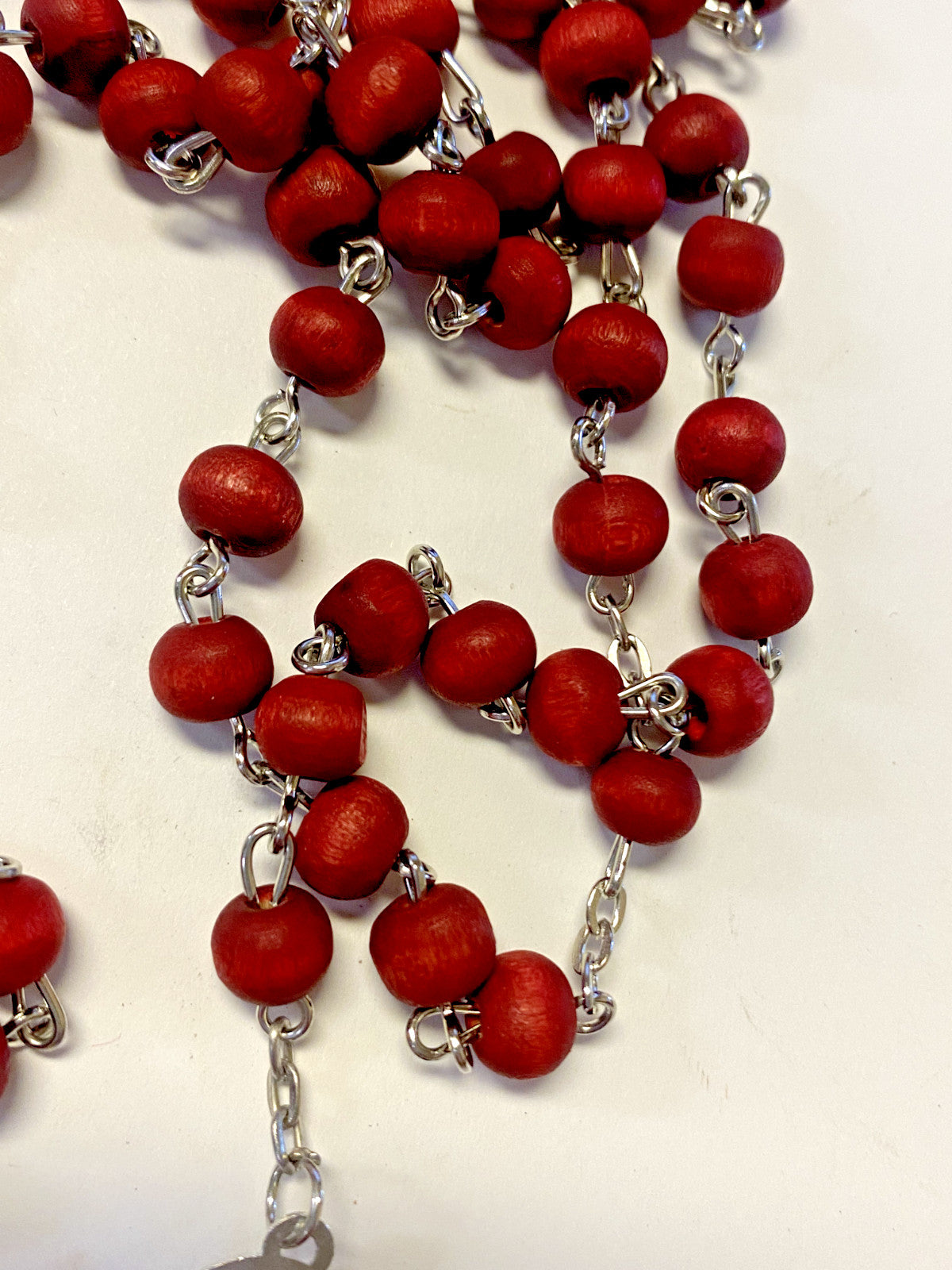 Lady of Guadalupe rose scented rosary by Bob and Penny Lord, featuring beads and a detailed religious medal for Christian devotion.