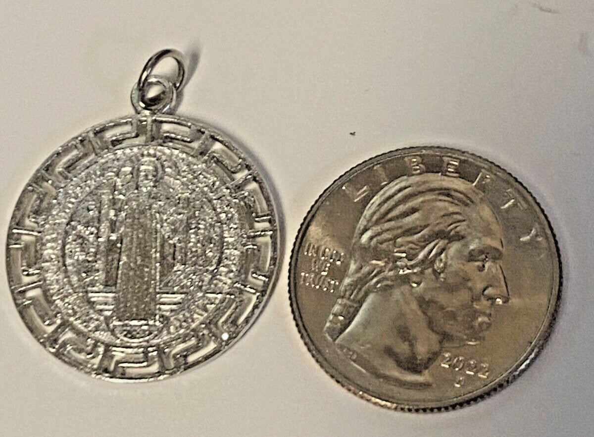 Silver tone Saint Benedict laser-engraved medal, 1 inch diameter, featuring religious imagery, from Bob and Penny Lord collectibles.