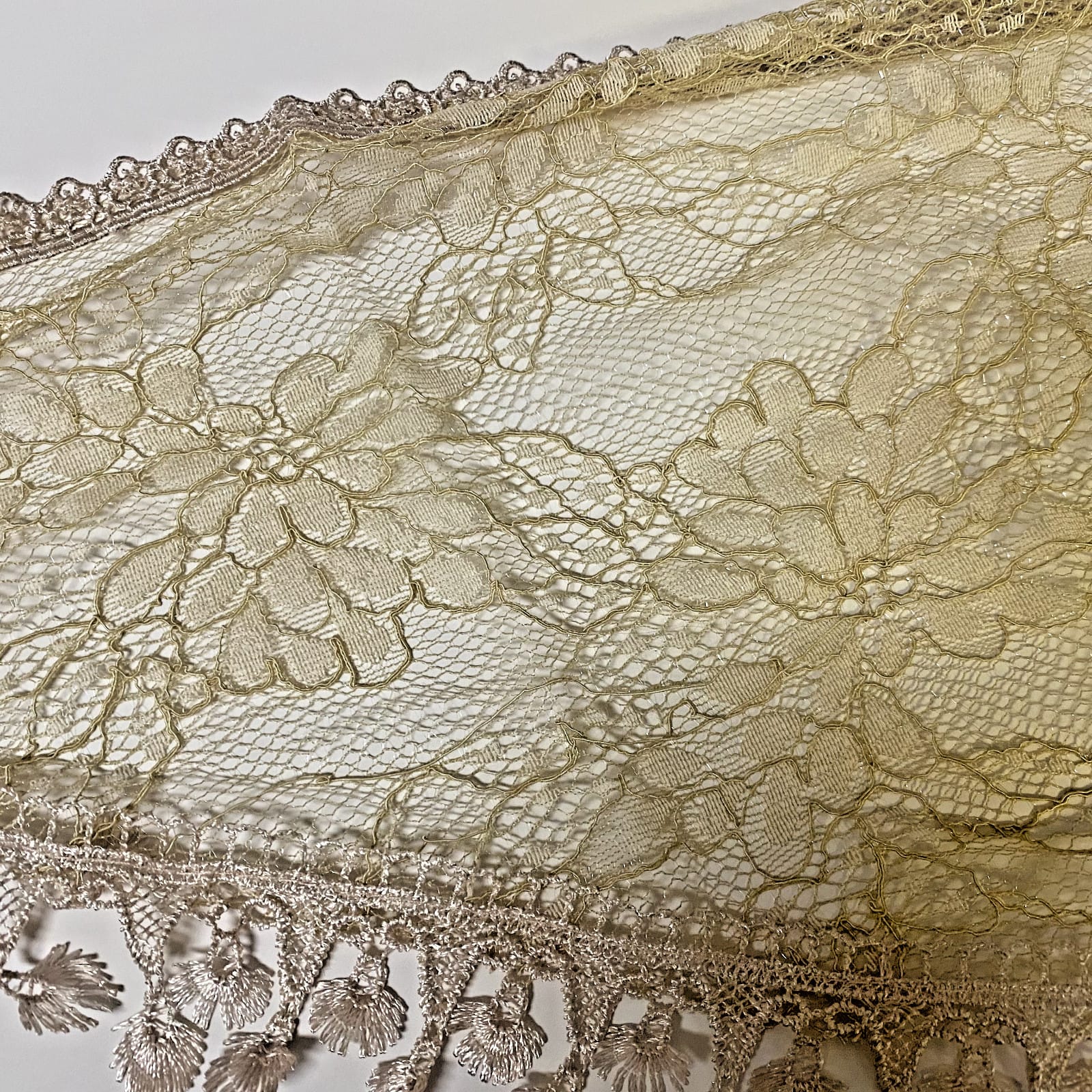 Women's light khaki lace church veil, a delicate accessory with intricate lace details, ideal for special occasions or religious events.