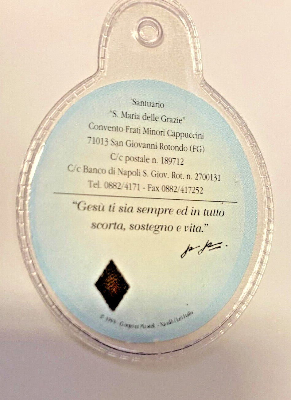 Plastic encased Padre Pio 3rd class relic, religious Christian collectible from Italy, by Bob and Penny Lord.