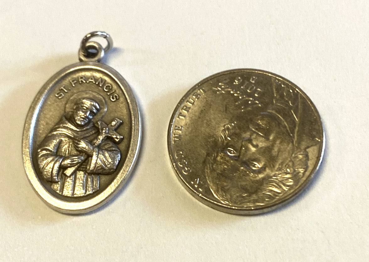 Silver tone Saint Francis of Assisi medal from Italy, Christian religious collectible with detailed religious imagery.