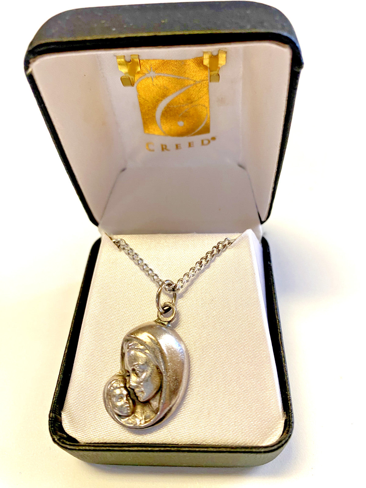 Blessed Mother with Child pendant on a 20-inch fashion jewelry necklace, detailed religious jewelry accessory.