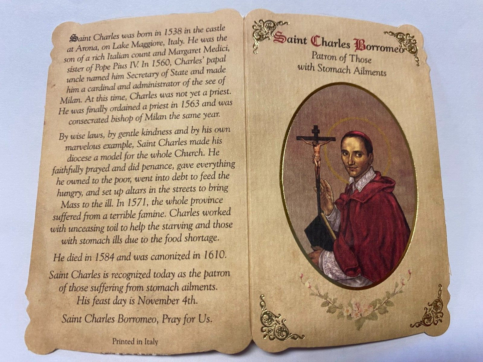 Saint Charles Borromeo prayer card and medal from Bob and Penny Lord, featuring religious imagery and Christian symbolism.