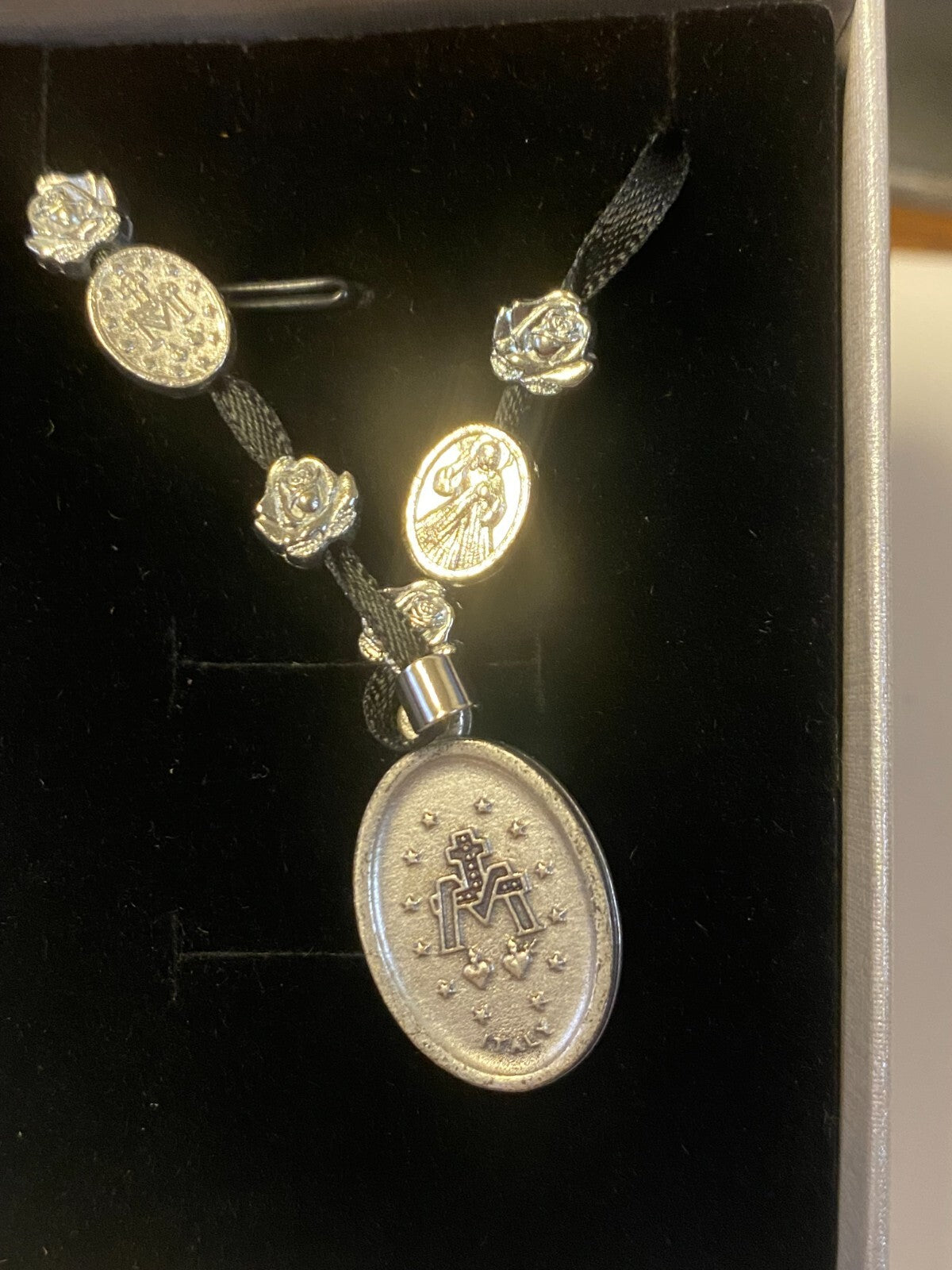 Art print of St. Michael, Divine Mercy, Miraculous Medal, and Our Lady Guadalupe ribbon necklace by Journeys of Faith.