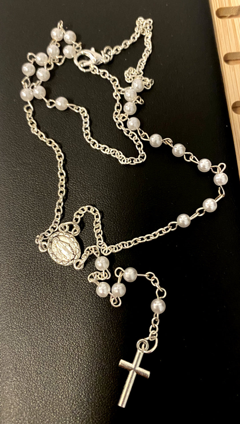 White faux pearl rosary necklace, 18 inches long, with silver-tone crucifix and beads, designed for Christian spirituality.