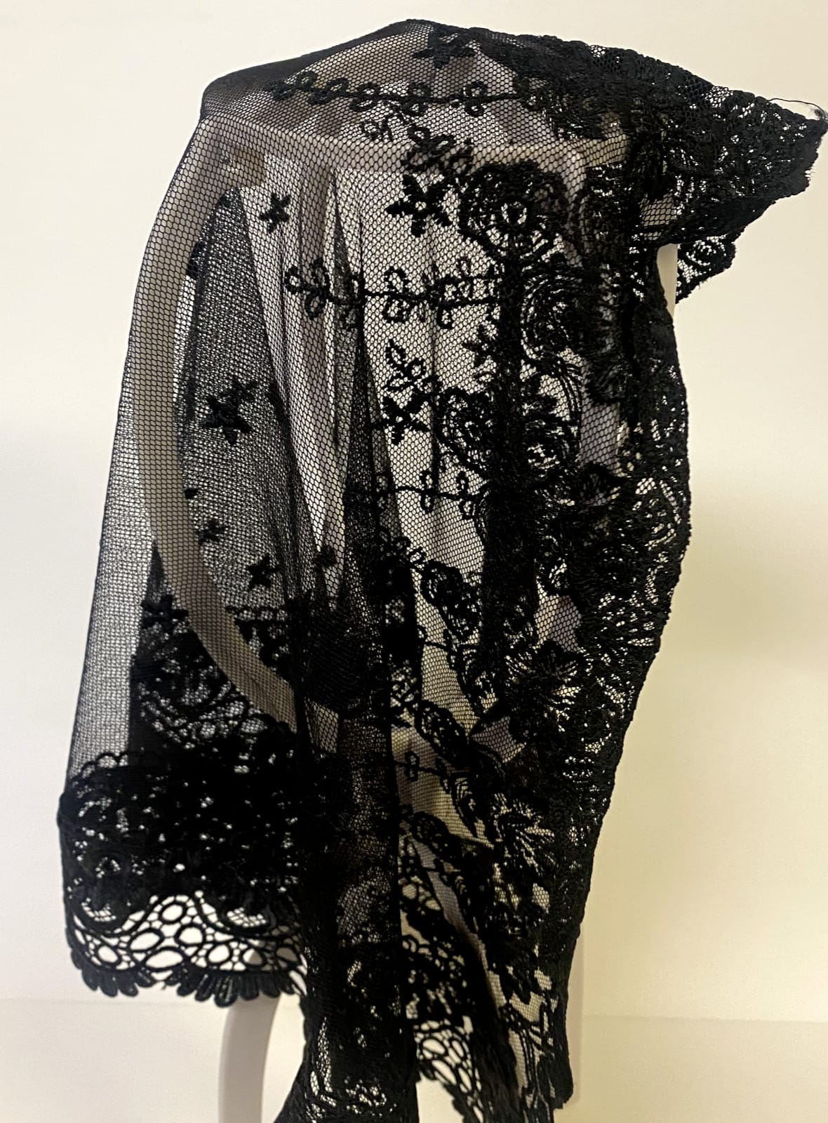 Women's black lace church veil with delicate floral lace details, lightweight and elegant for special religious occasions.