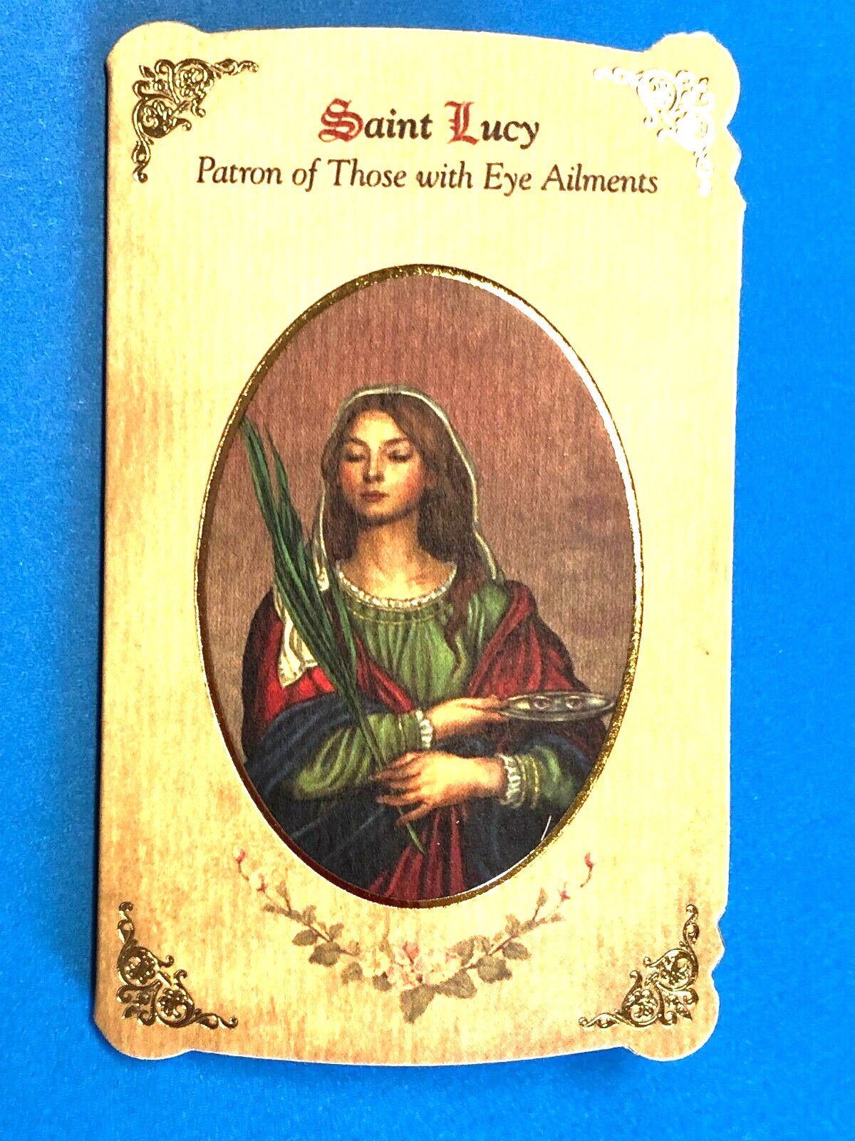Saint Lucy novena card with medal, Christian holy card featuring image of Saint Lucy, patron of eye ailments, by Bob and Penny Lord.
