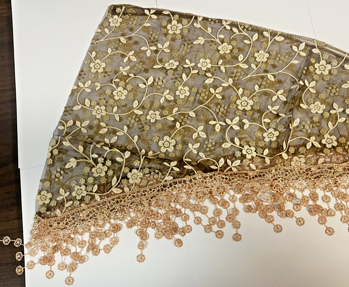 Women's brown lace church veil with floral lace detailing, designed as a head covering or accessory for special occasions.