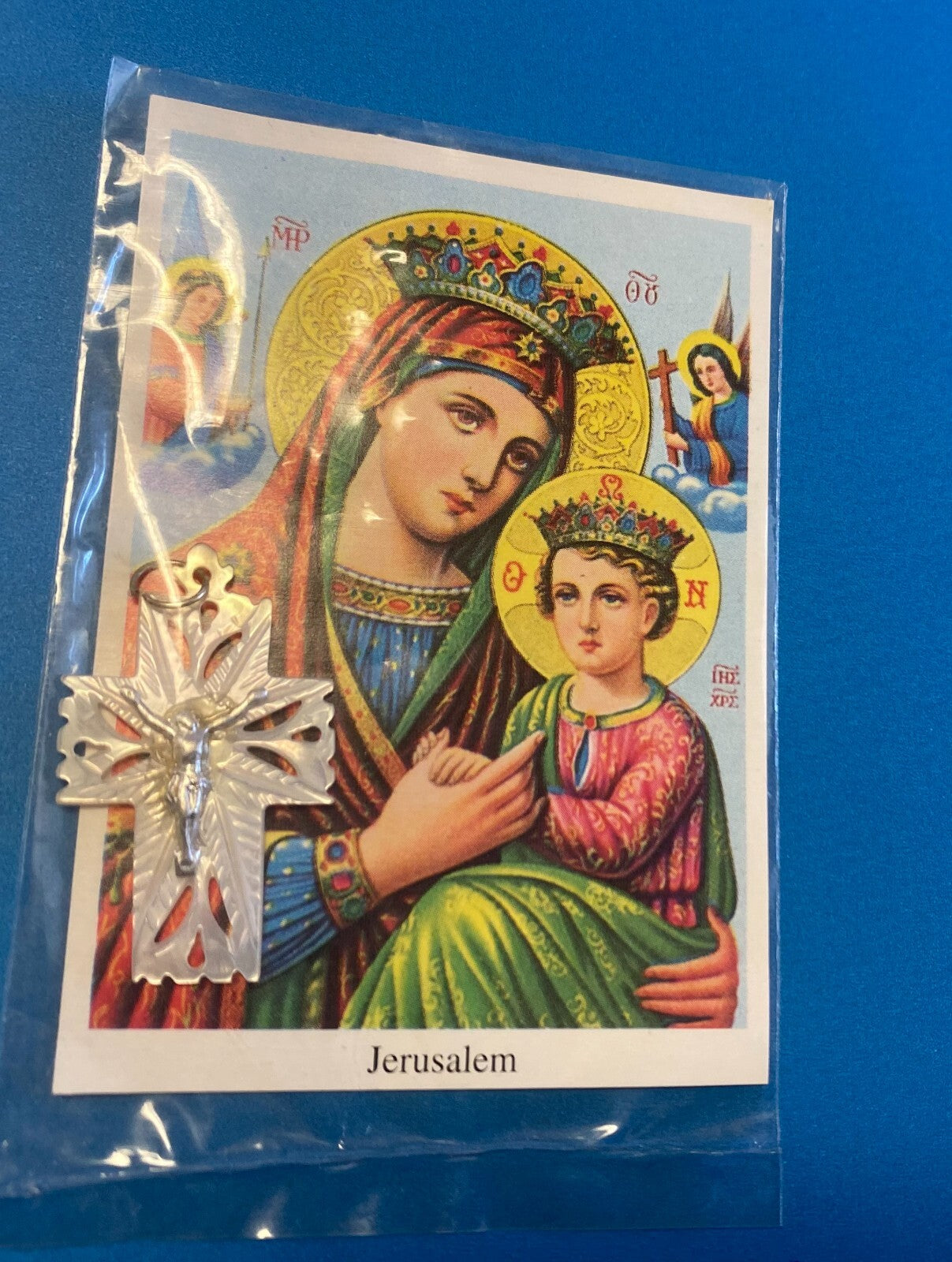 Image of Our Lady of Perpetual Help religious print with a mother of pearl crucifix pendant, by Bob and Penny Lord.