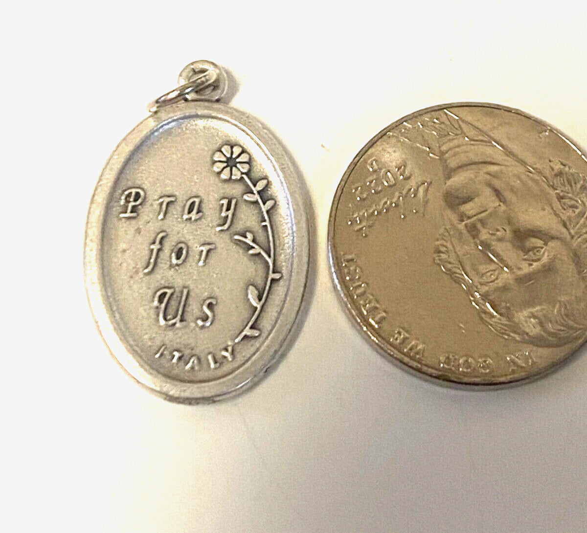 Silver tone Our Lady of Perpetual Help medal by Bob and Penny Lord, featuring religious imagery, suitable for Christian collectibles.