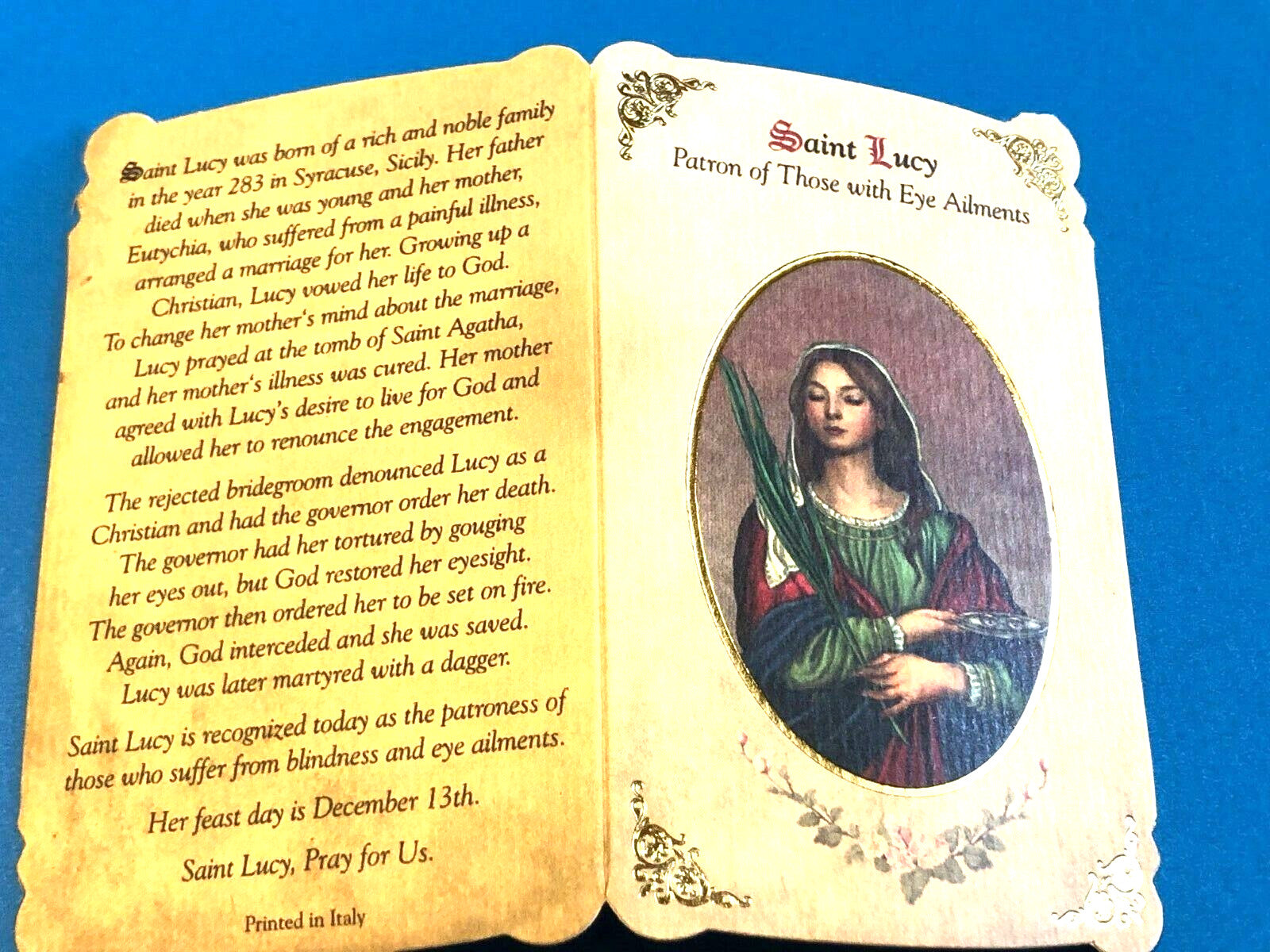 Saint Lucy Novena card with medal, featuring religious imagery of Saint Lucy, the patron saint of eye ailments, from Bob and Penny Lord.