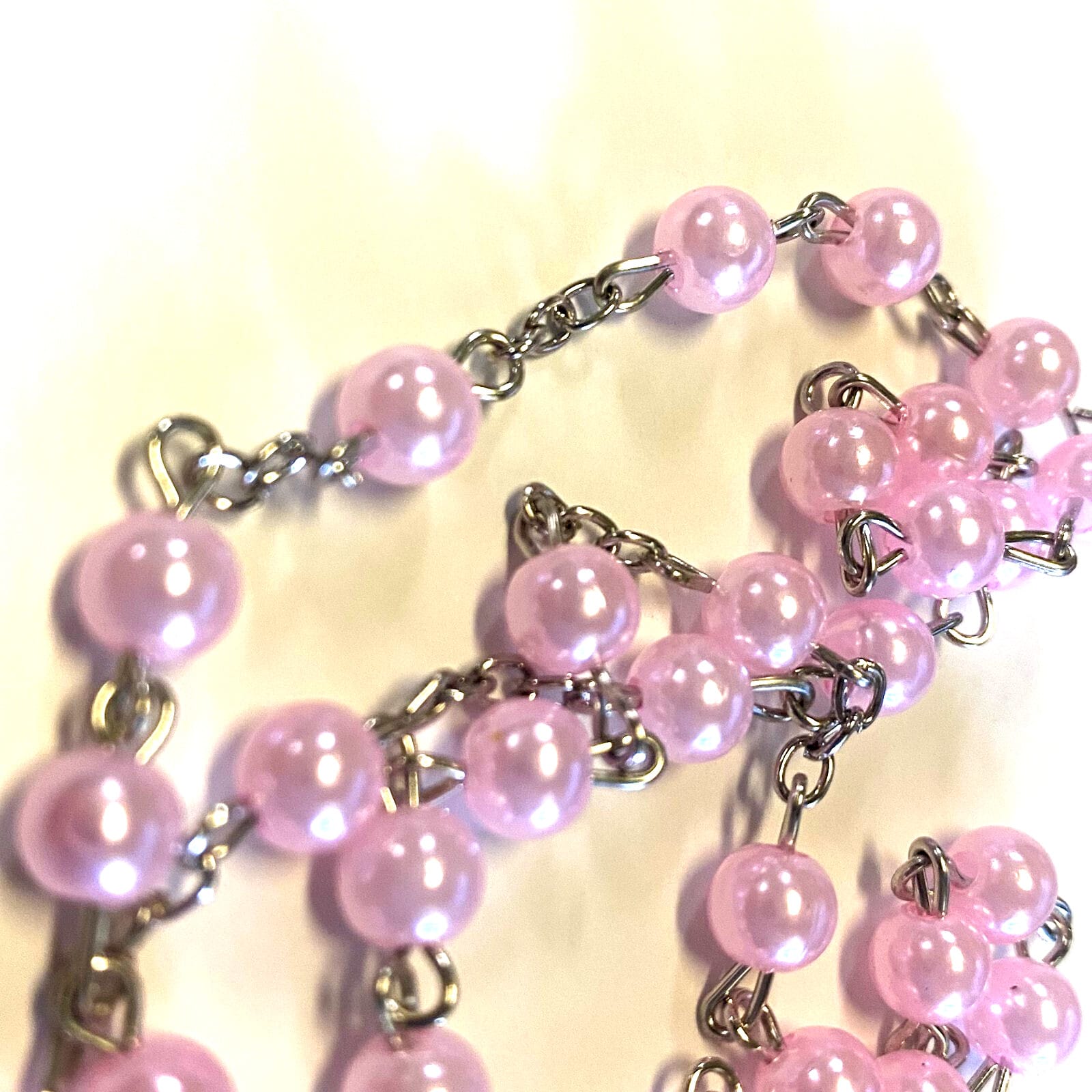 Pink rosary with Christian cross and beads, a Baptism-themed religious collectible from Journeys of Faith.