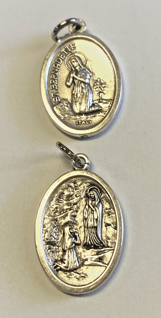 Small two-sided St. Bernadette/Our Lady of Lourdes medal by Bob and Penny Lord, featuring religious imagery on both sides.