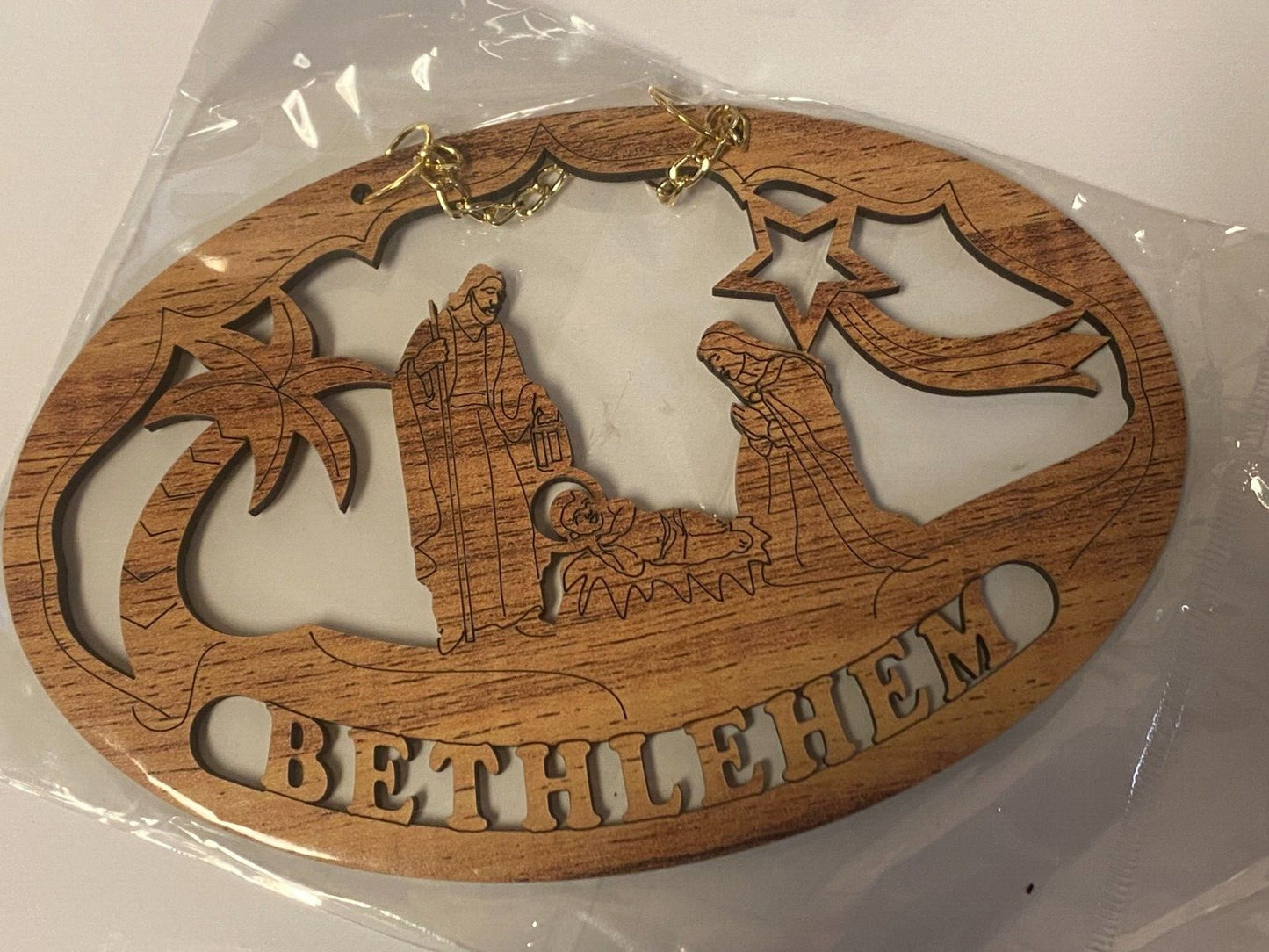 Carved olive wood Nativity Scene wall sign by Bob and Penny Lord, depicting the nativity figures for Christian holiday decor.
