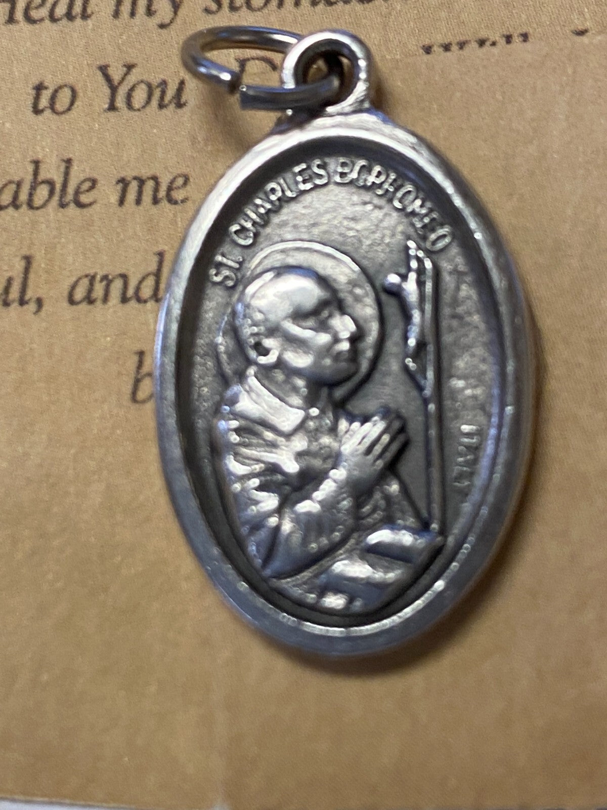 Saint Charles Borromeo prayer card and medal collectible from Bob and Penny Lord, featuring religious imagery and Christian symbolism.