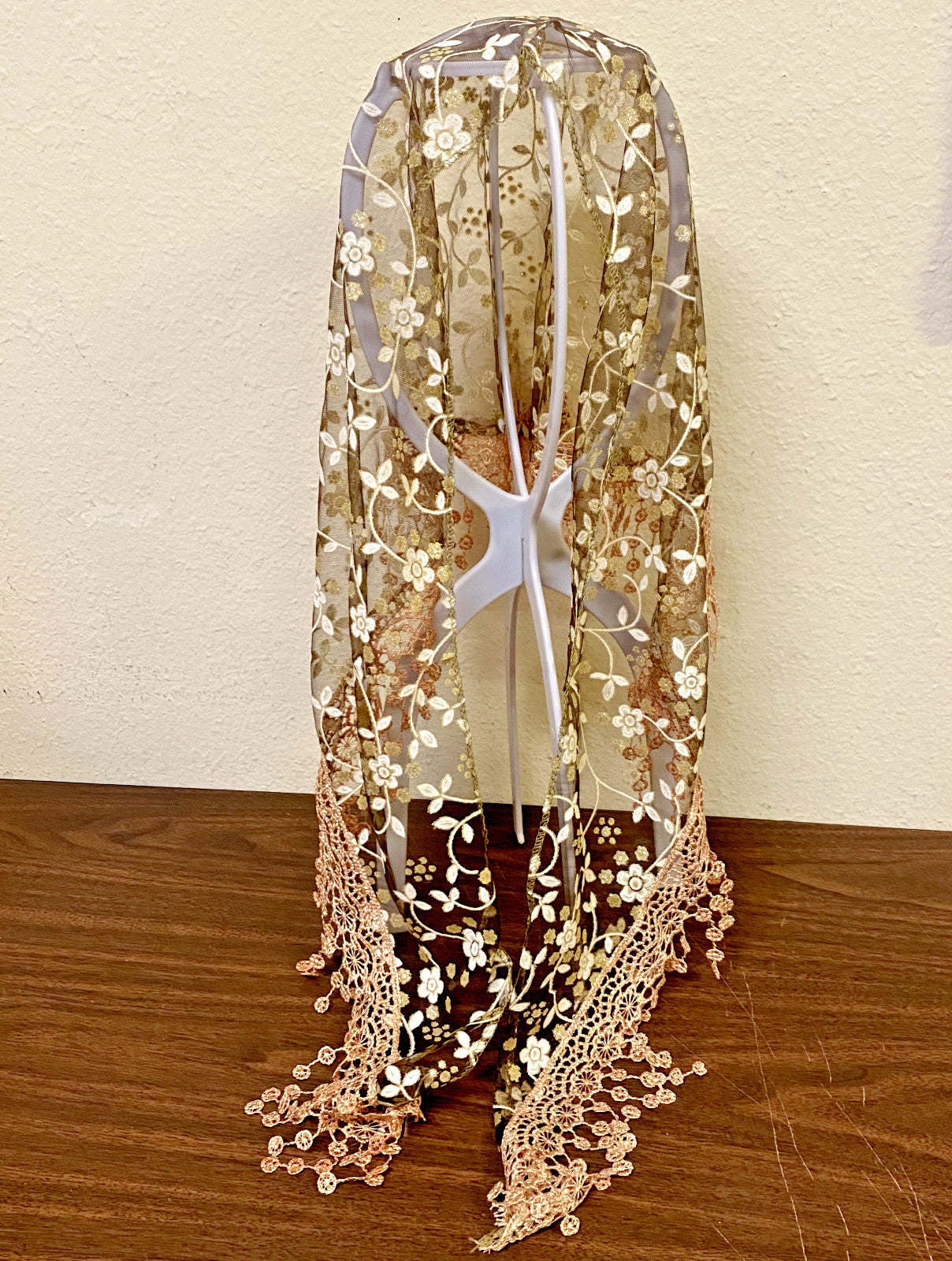 Women’s brown lace church veil with delicate floral pattern, designed as a stylish accessory for special occasions.