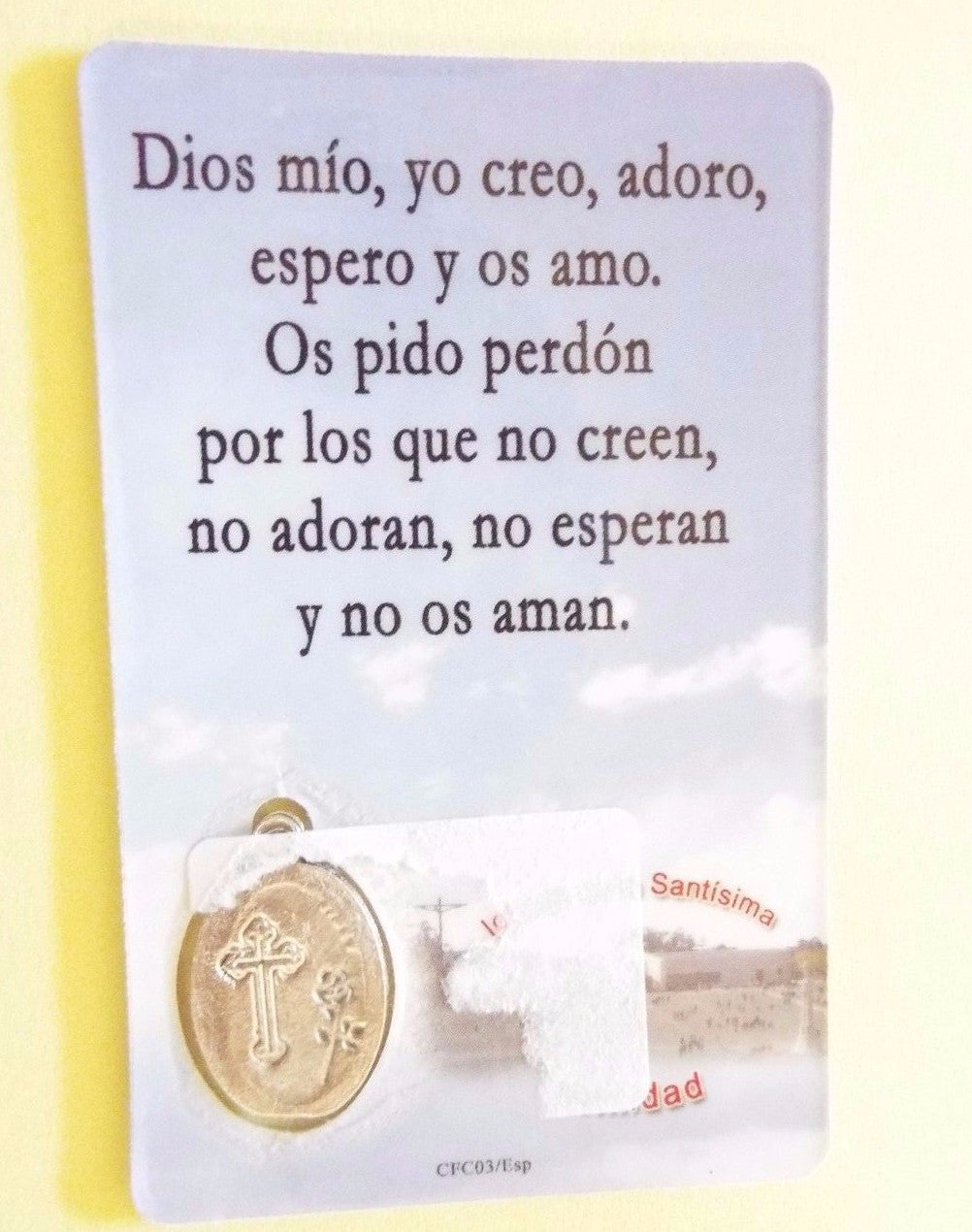Holy card of Our Lady of Fátima with a Fátima medal, featuring religious imagery on cardstock, by Bob and Penny Lord.