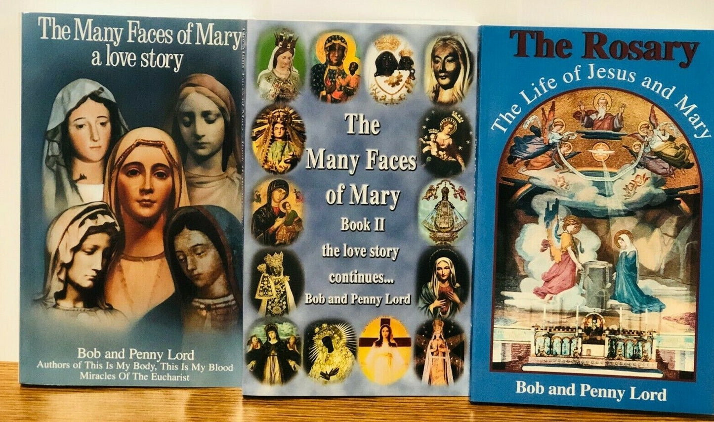 Set of three religious books by Bob and Penny Lord, including The Many Faces of Mary, The Rosary, and The Life of Jesus and Mary.