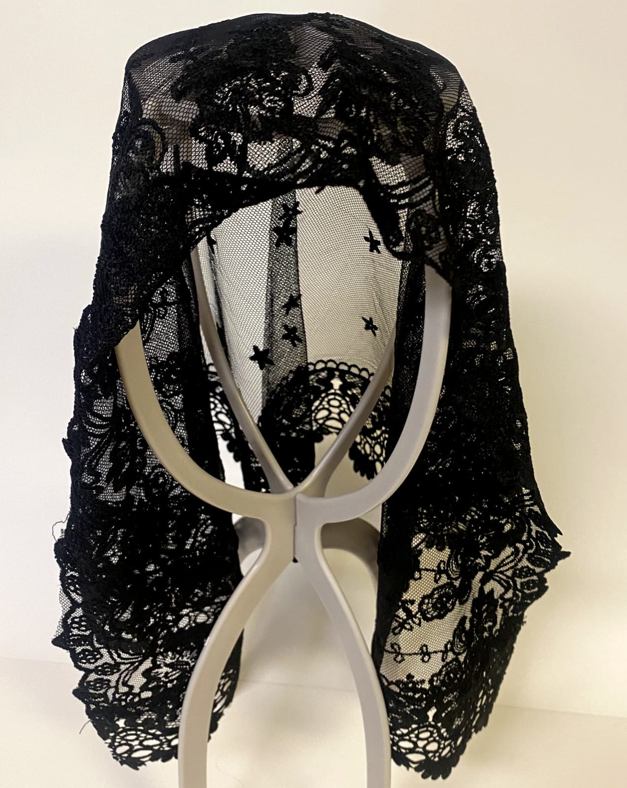 Black lace women's church veil with delicate floral pattern, lightweight and semi-sheer, perfect for religious ceremonies and special occasions.