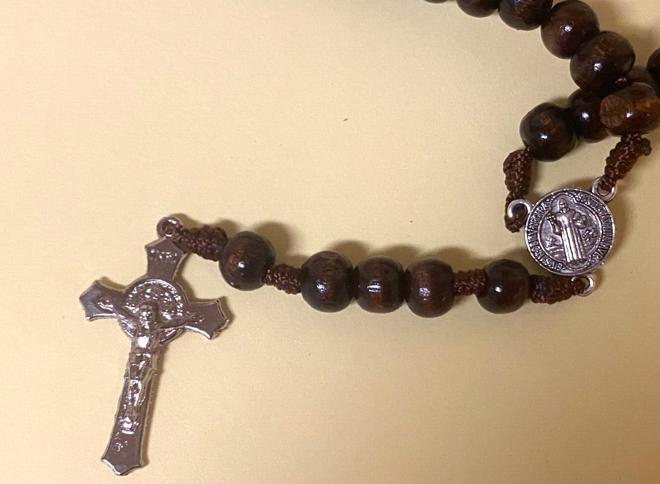 Wood rosary box with Padre Pio design and a Christian rosary inside, collectible religious item from Bob and Penny Lord.