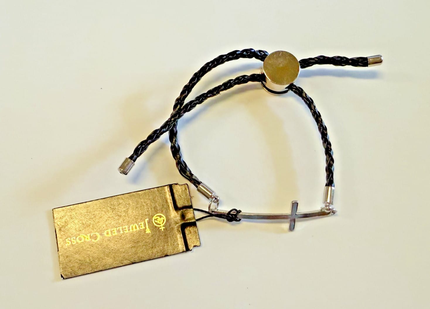 Silver tone cross bracelet with adjustable cord from Journeys of Faith, featuring a Christian religious jewelry design.