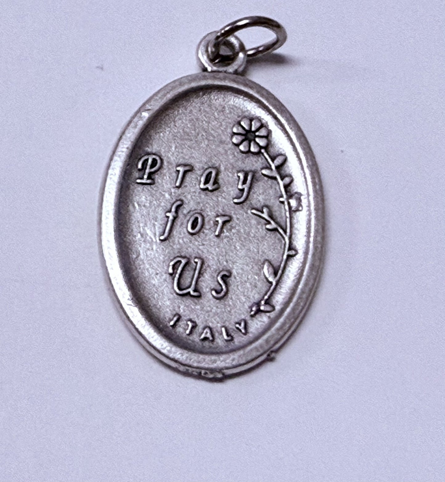 Silver tone Our Lady of Perpetual Help medal featuring religious imagery, designed for Christian collectibles and spirituality.