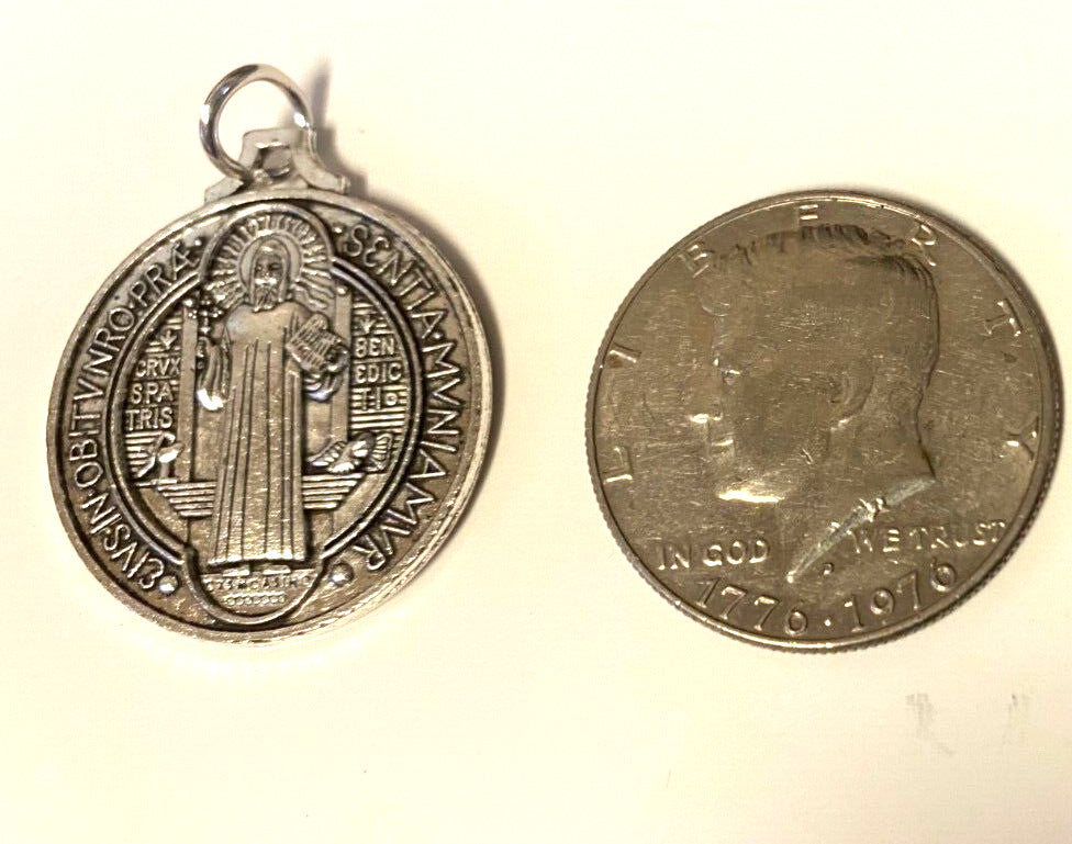 Large silver-tone Saint Benedict medal, 1.25 inches in diameter, featuring religious symbolism, by Bob and Penny Lord.