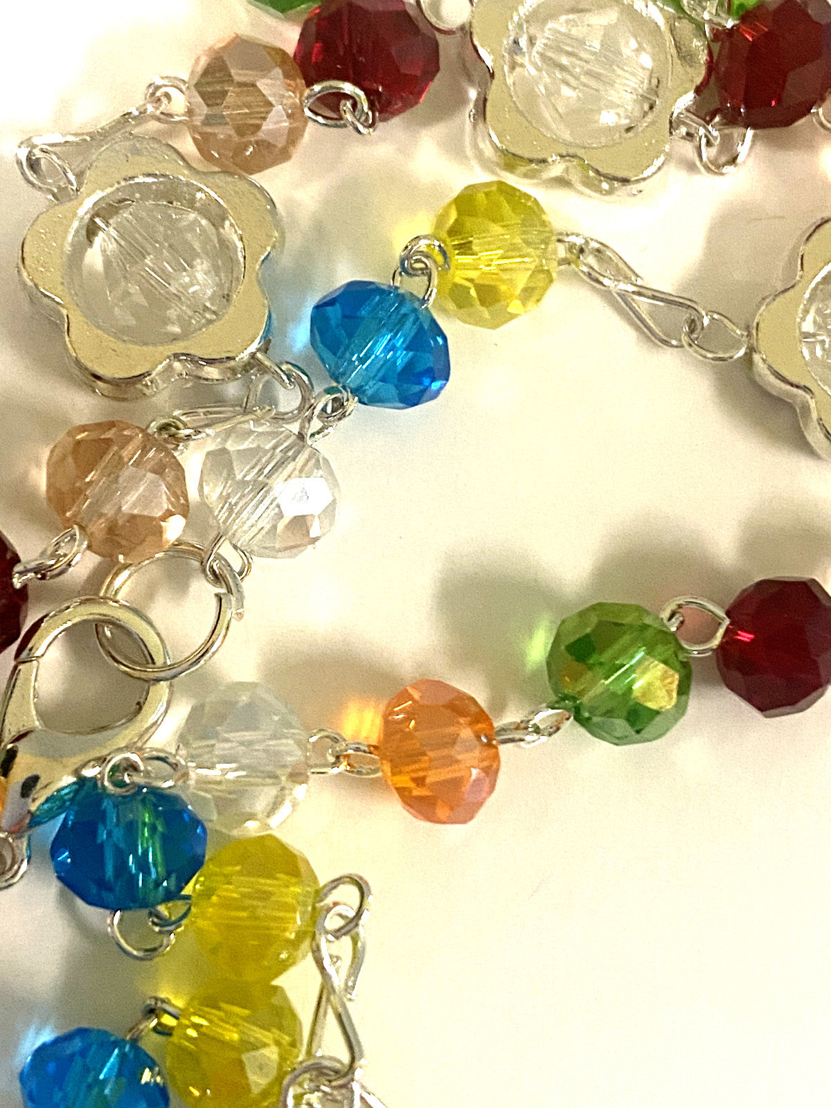 Multi-color handmade rosary with beaded strands and cross, crafted in Colombia by Bob and Penny Lord for Christian spirituality.