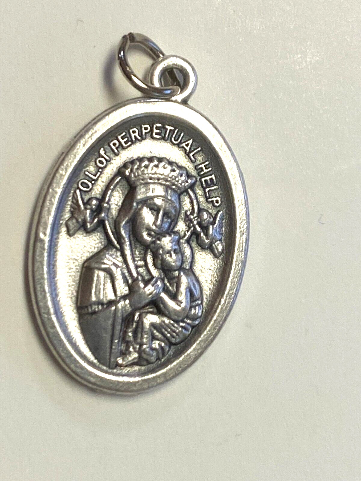 Silver tone Saint Gerard Majella and Our Lady of Perpetual Help medal with religious imagery, religious medals by Bob and Penny Lord.