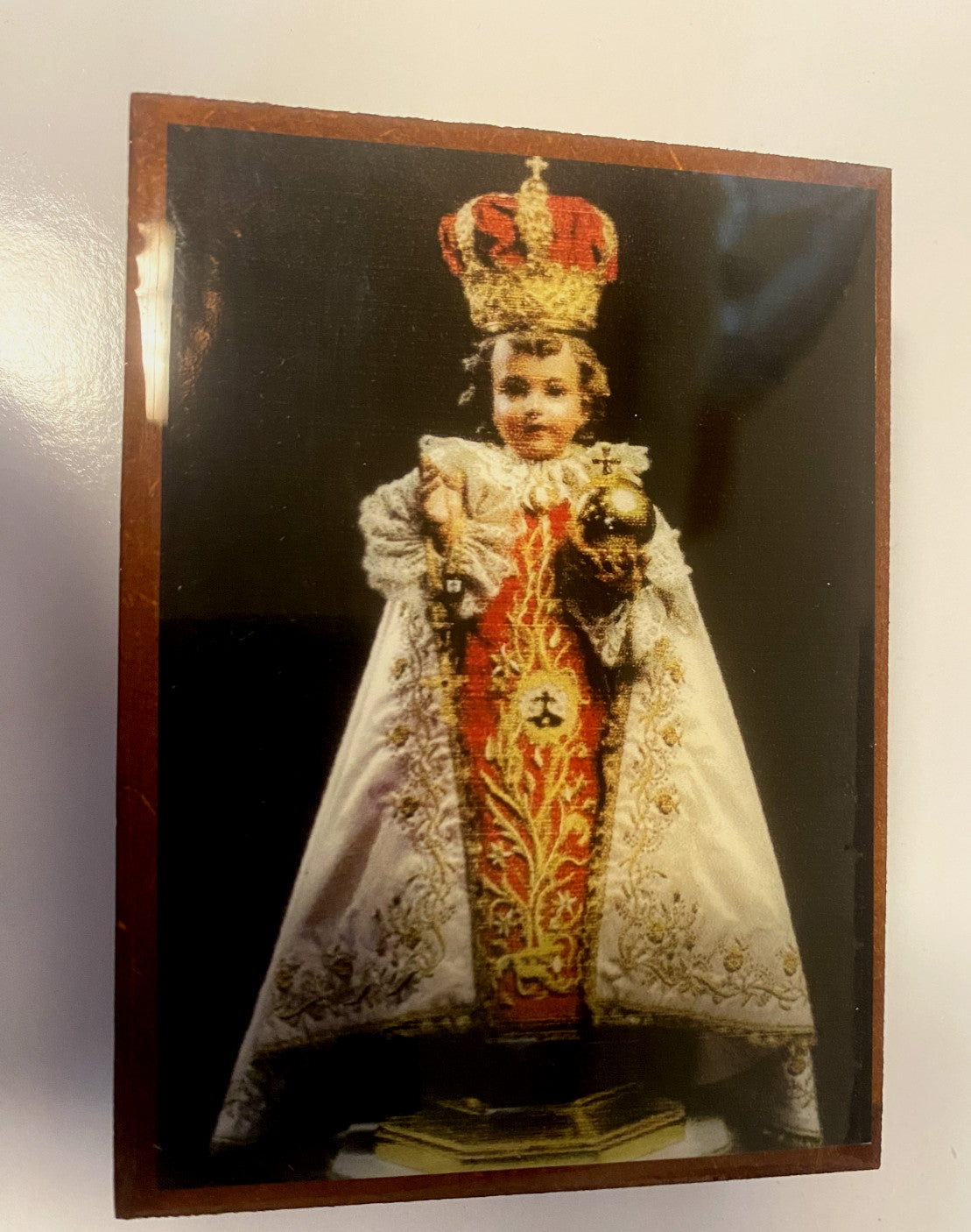 Wooden Infant of Prague rosary box with attached rosary, featuring religious Christian symbols, handcrafted in Colombia by Bob and Penny Lord.