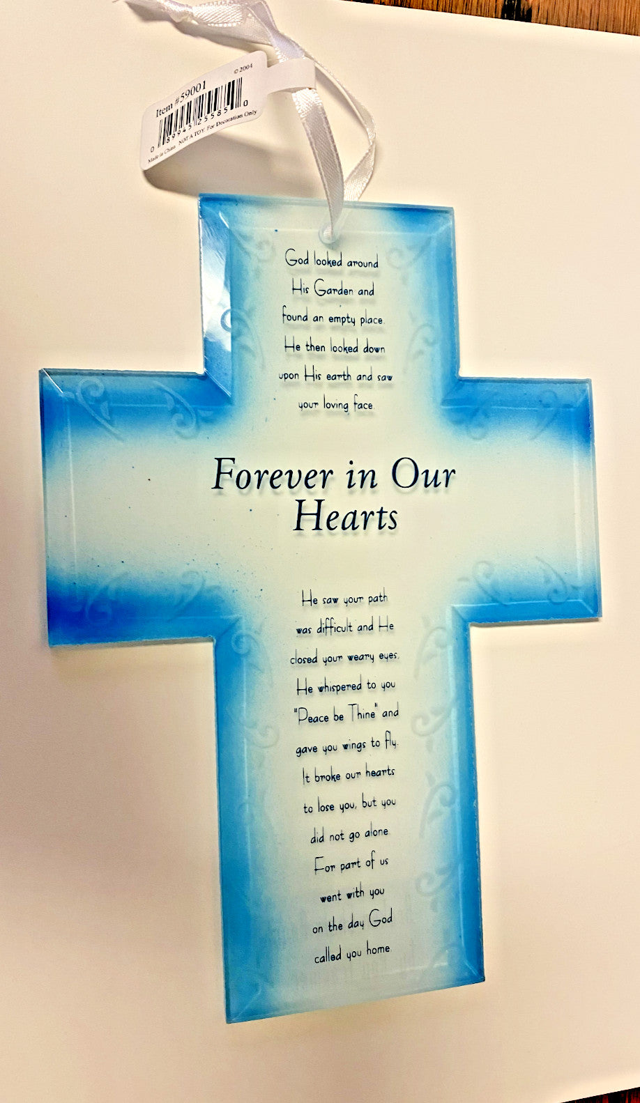 Roman blue glass cross with broken chain decorative collectible, featuring a poem, displayed on a neutral background.