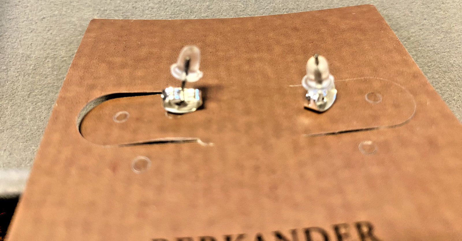 Berkander cross stud earrings with small silver crosses, jewelry and fashion earrings for women, displayed on a white background.