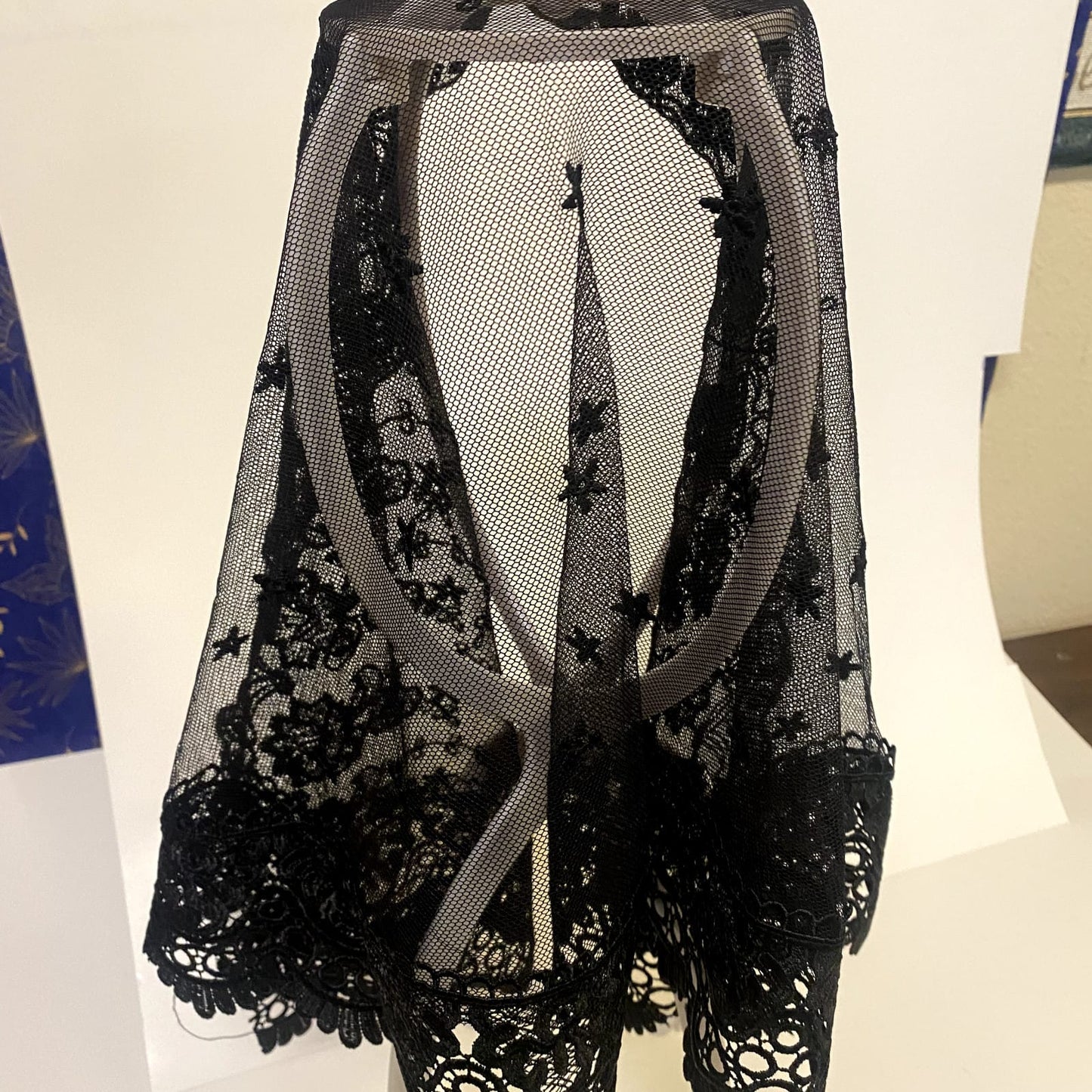 Black lace women's church veil with delicate floral pattern, lightweight and elegant accessory for special occasions.