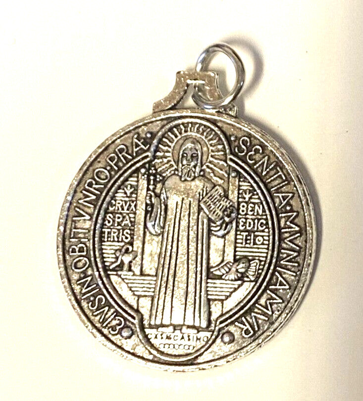 Large silver tone Saint Benedict medal, 1.25-inch diameter, featuring religious symbols, from Bob and Penny Lord collectibles collection.