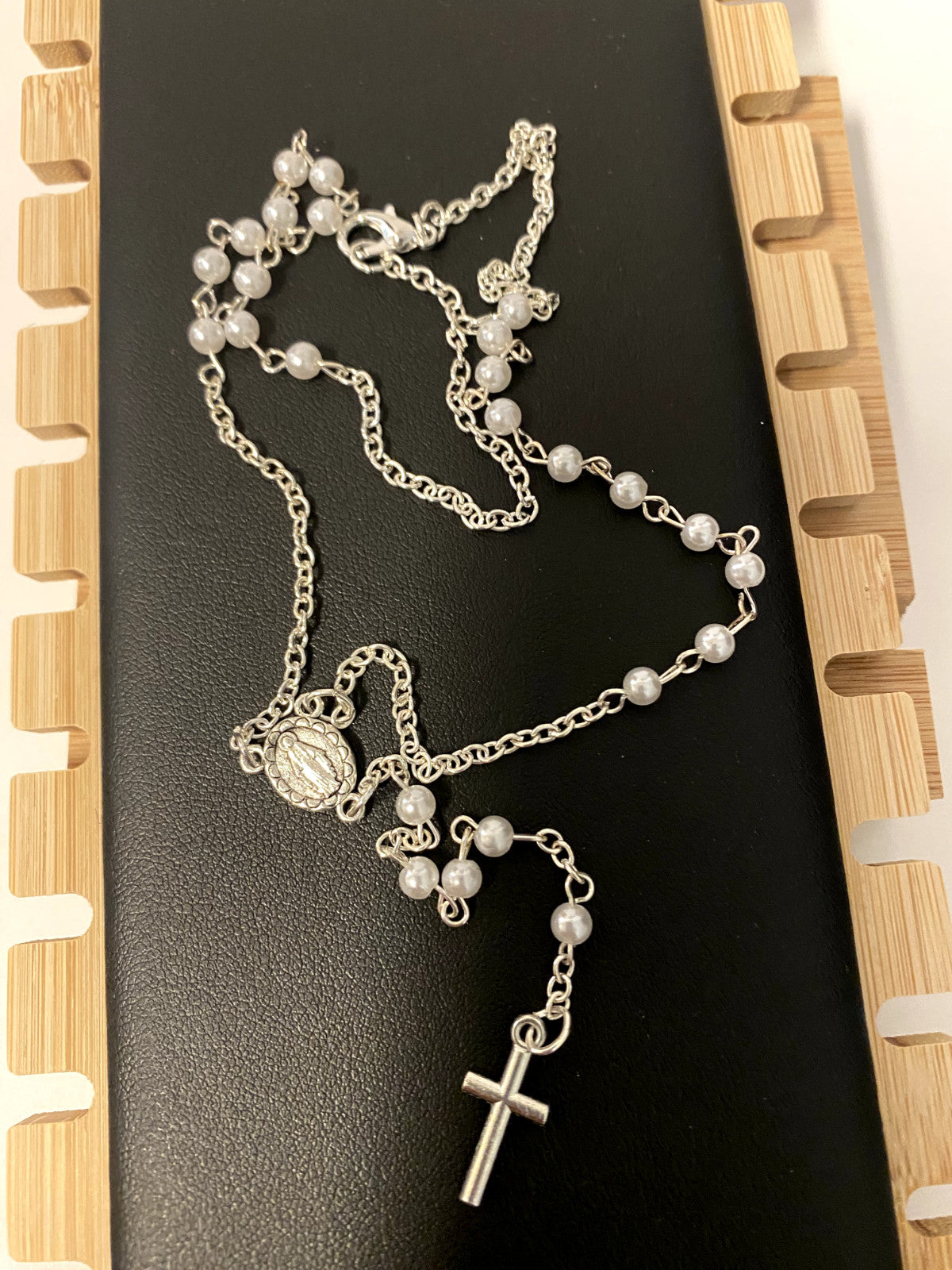 White faux pearl rosary necklace, 18 inches long, featuring round beads, Christian spirituality accessory by Bob and Penny Lord.
