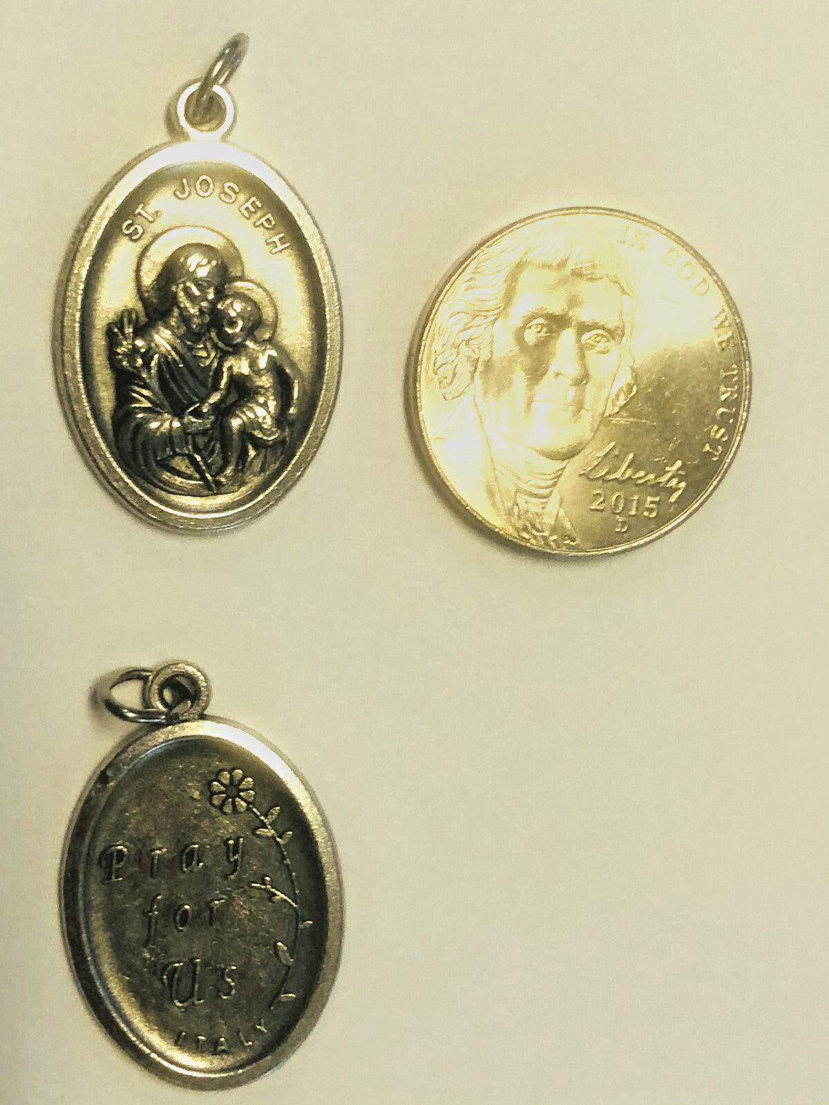 Saint Joseph with Child Jesus medal from Italy, featuring detailed religious imagery on a Christian Holy Card.