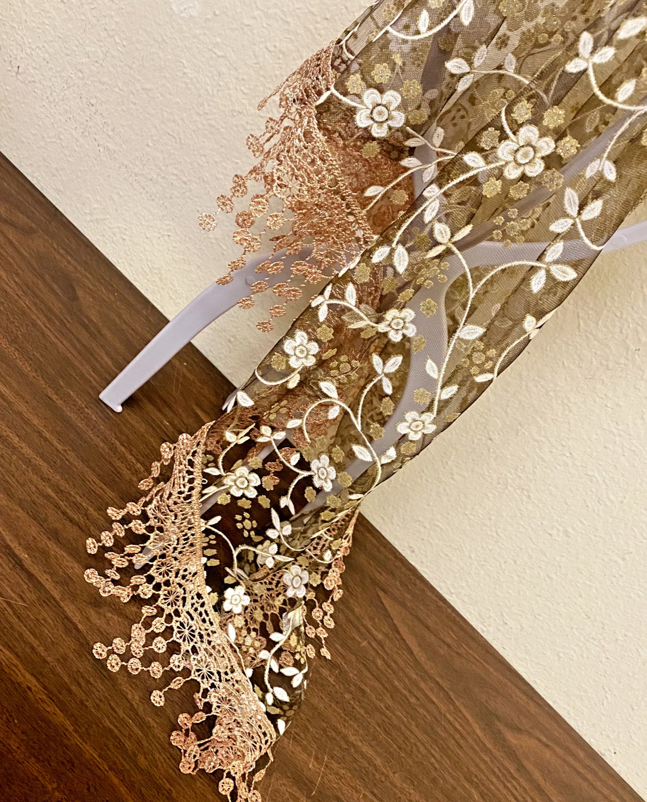 Women's brown lace church veil with delicate floral pattern, designed for formal accessories and religious attire.