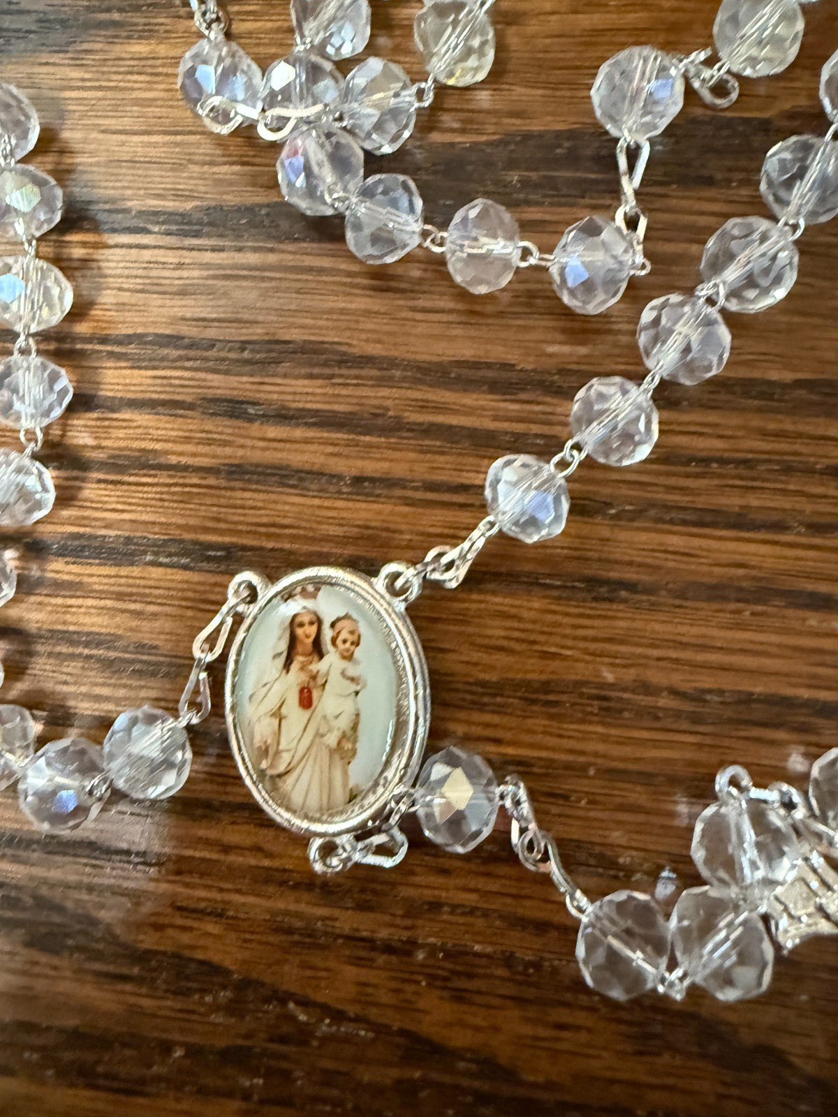 Iridescent beads handmade rosary from Colombia with Catholic religious symbolism, featuring shiny beads and a crucifix.