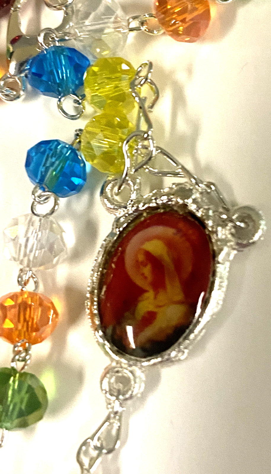 Colorful handmade rosary with multicolored beads from Colombia, featuring Christian cross and the Bob and Penny Lord branding.