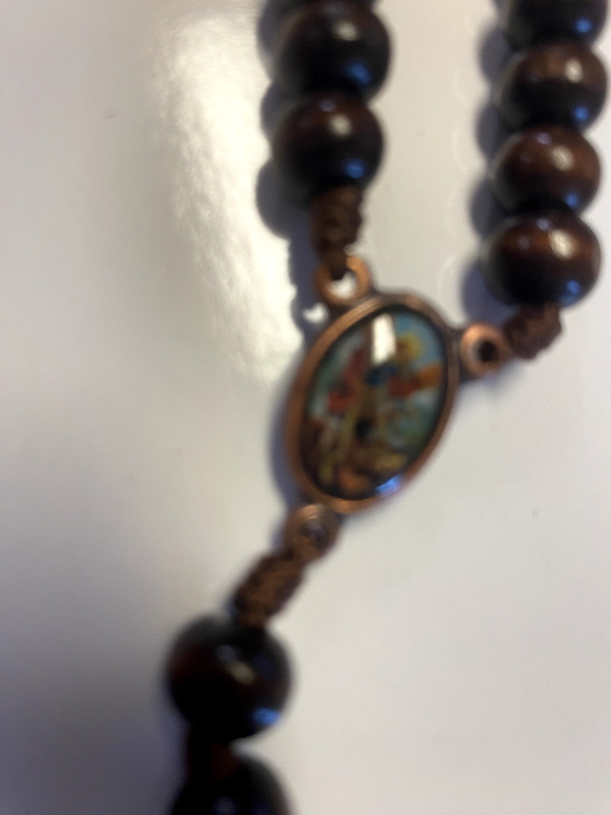 Wood rosary box with St Michael the Archangel design from Colombia, containing a Christian rosary, by Bob and Penny Lord.
