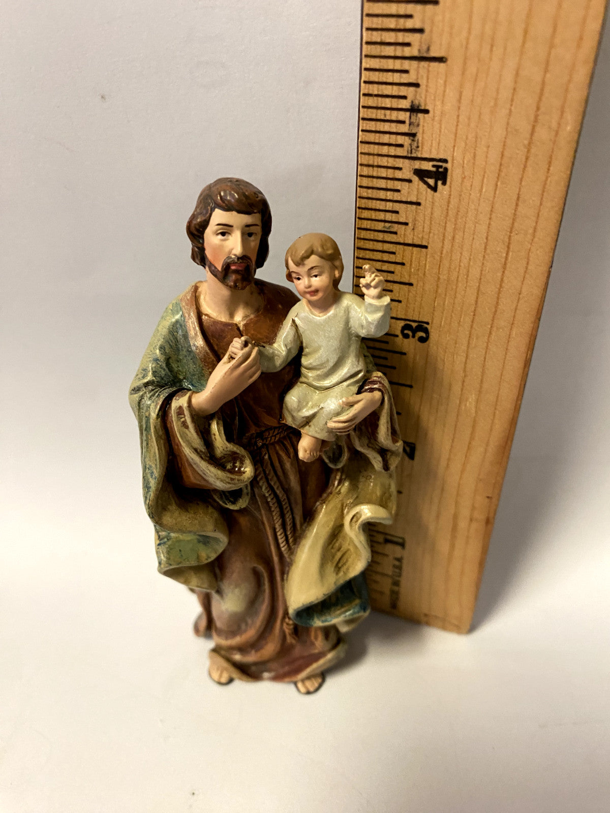 Saint Joseph with Child 4-inch statue by Bob and Penny Lord, depicting Saint Joseph holding the Child Jesus in a detailed religious figurine.