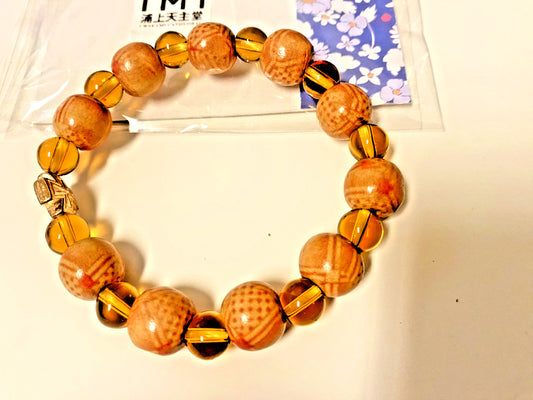 Light brown wood and clear bead stretch bracelet by Bob and Penny Lord, Christian jewelry, featuring natural wooden and glass beads.