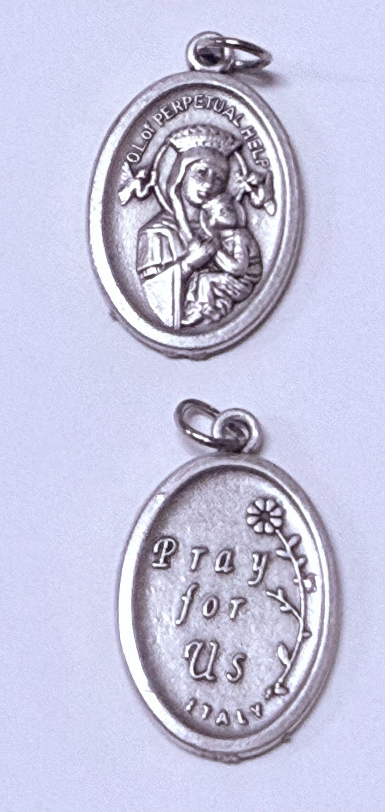 Silver tone Our Lady of Perpetual Help medal by Bob and Penny Lord, Christian religious collectible, detailed depiction of the Virgin Mary.