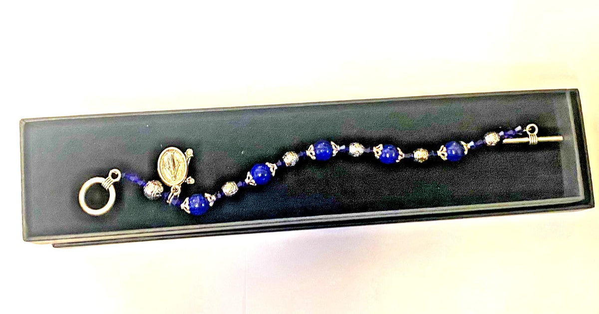 Miraculous Medal sapphire Madonna del Parto bracelet featuring religious jewelry with a silver medal and sapphire accents.