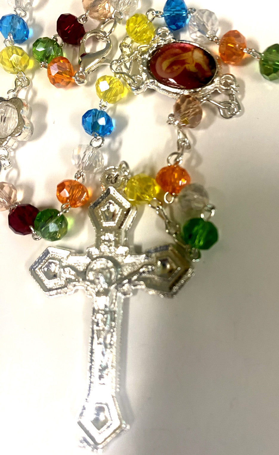 Multi-color handmade rosary from Colombia by Bob and Penny Lord, featuring vibrant beads and detailed craftsmanship.