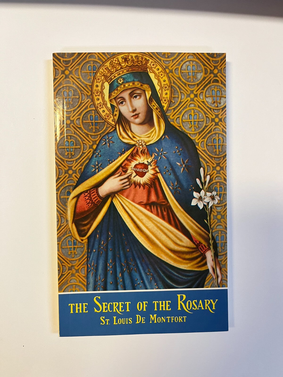 Paperback book titled "The Secret of the Rosary" by Bob and Penny Lord, featuring a cover with religious imagery.