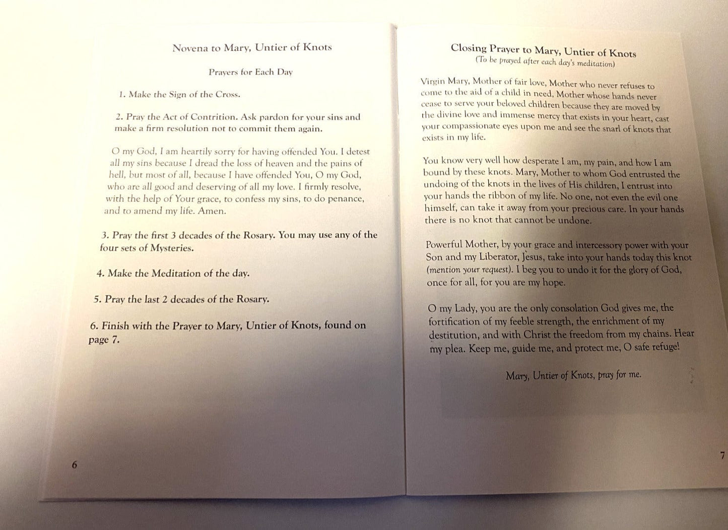 Close-up of the Our Lady Undoer of Knots prayer book by Bob and Penny Lord, featuring religious imagery and Christian holy card design.